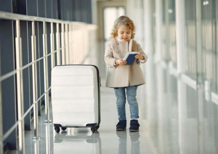 Little girl in an airport with a suitcase