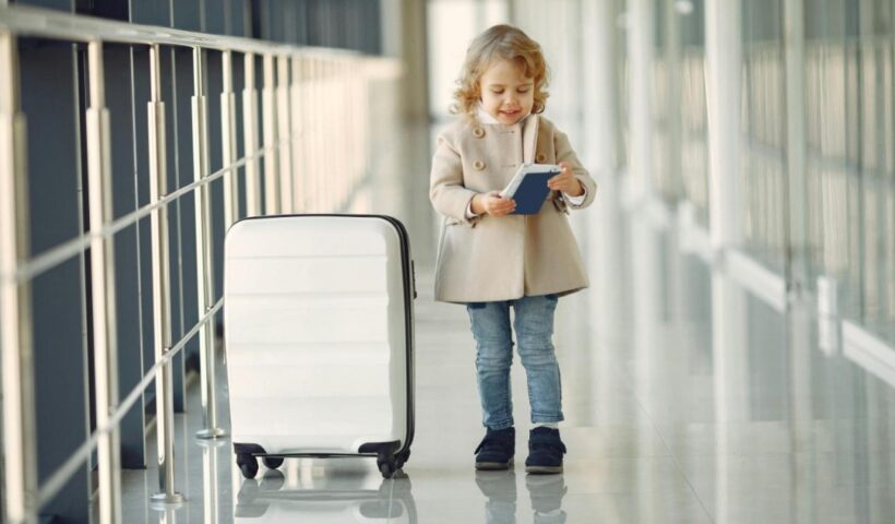 Little girl in an airport with a suitcase